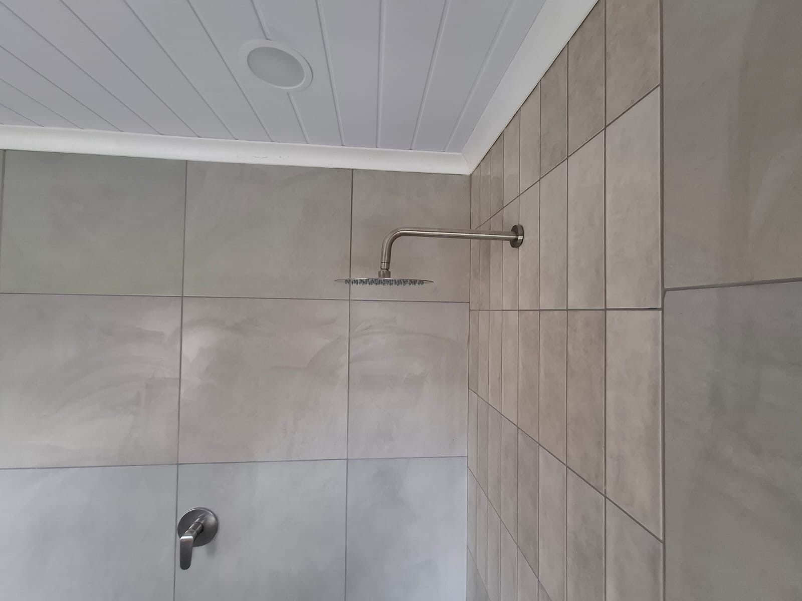 New shower head and tiling installation